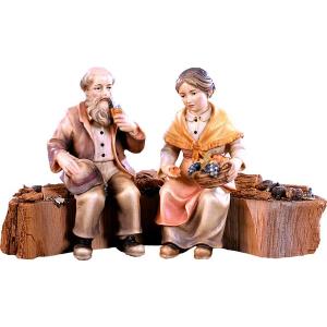 Bauernpaar auf Holzstamm für